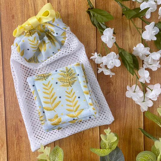 yellow foliage patterned skincare pads and washbag giftset on wood surface