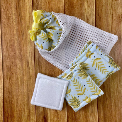 yellow foliage patterned skincare pads and washbag giftset sat on a wooden background