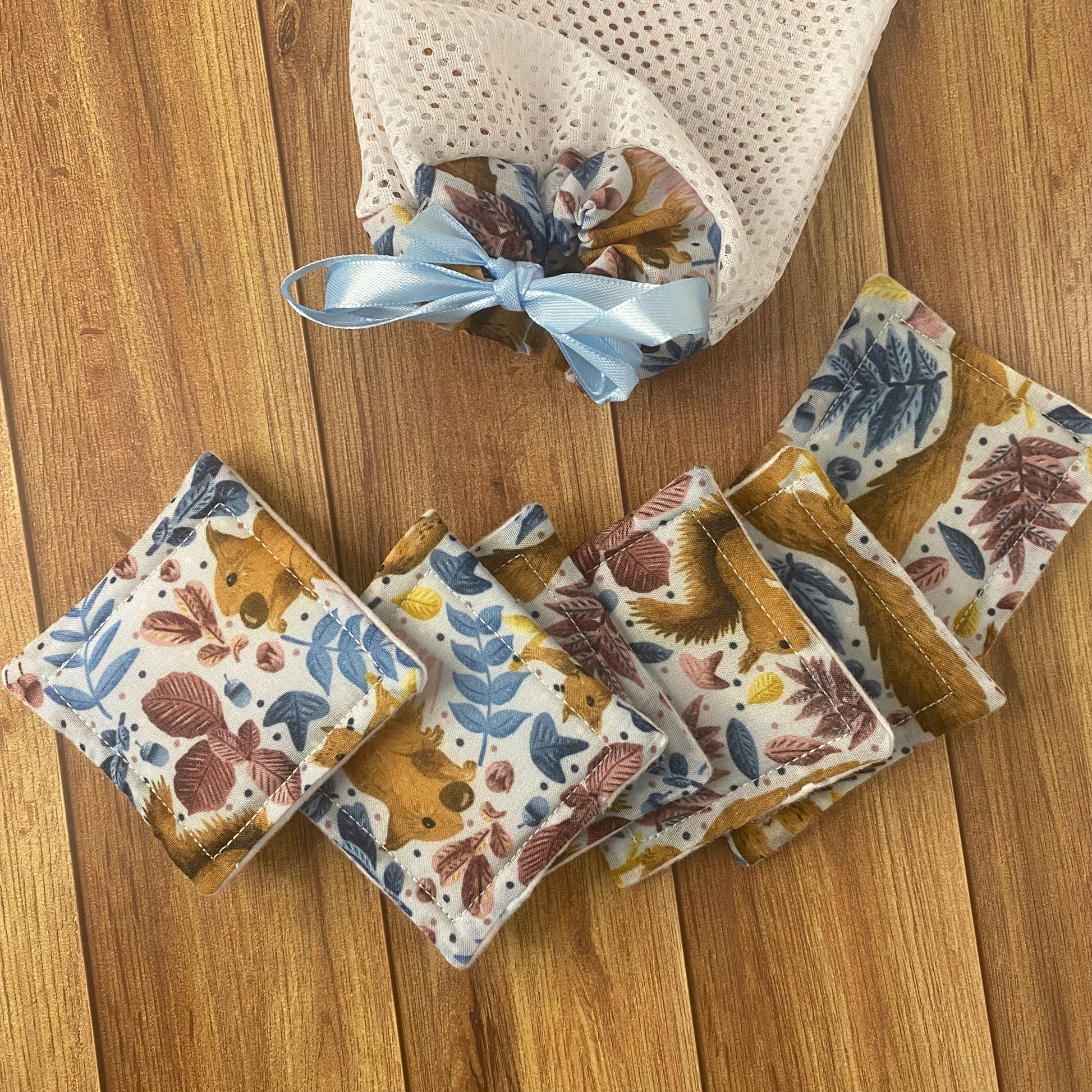 red squirrel patterned skincare pads and washbag on wood surface