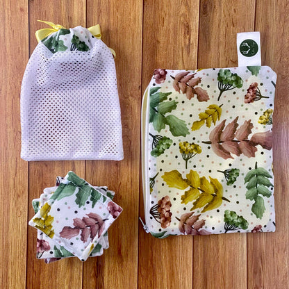 pouch, washbag and skincare pads matching with the pretty foliage pattern on wooden background