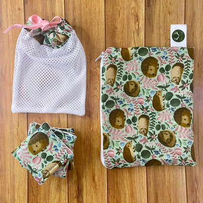 hedgehog pattern pouch, reusable skincare pads and washbag on wooden surface
