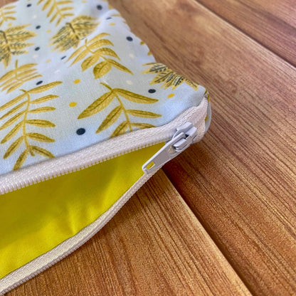 Closeup of white zip on the yellow foliage pouch, showing the yellow lining inside the cosmetic bag for handbag use. Spoil yourself with a gift for you today.