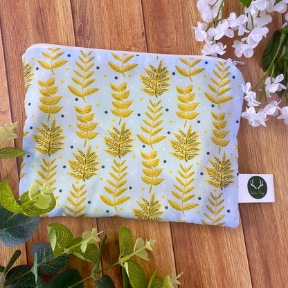 yellow foliage patterned pouch on wooden surface