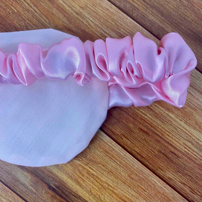 closeup of back of sleepmask showing pink backing and pink scrunched strap