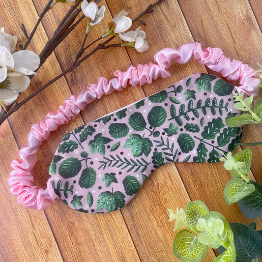 green foliage patterned sleepmask ona wooden background