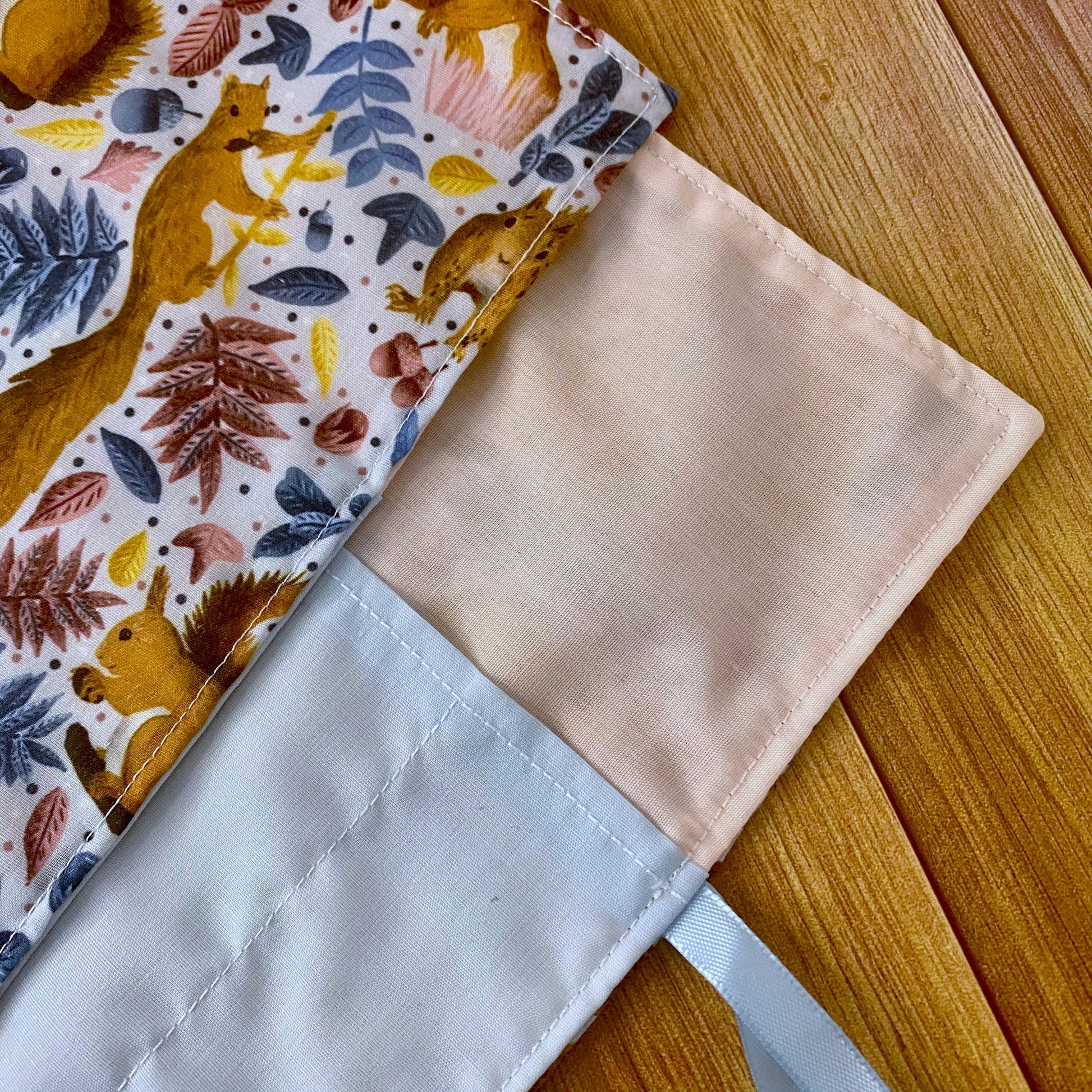 closeup of makeup bag roll up which works as a gift for a red squirrel lover.
