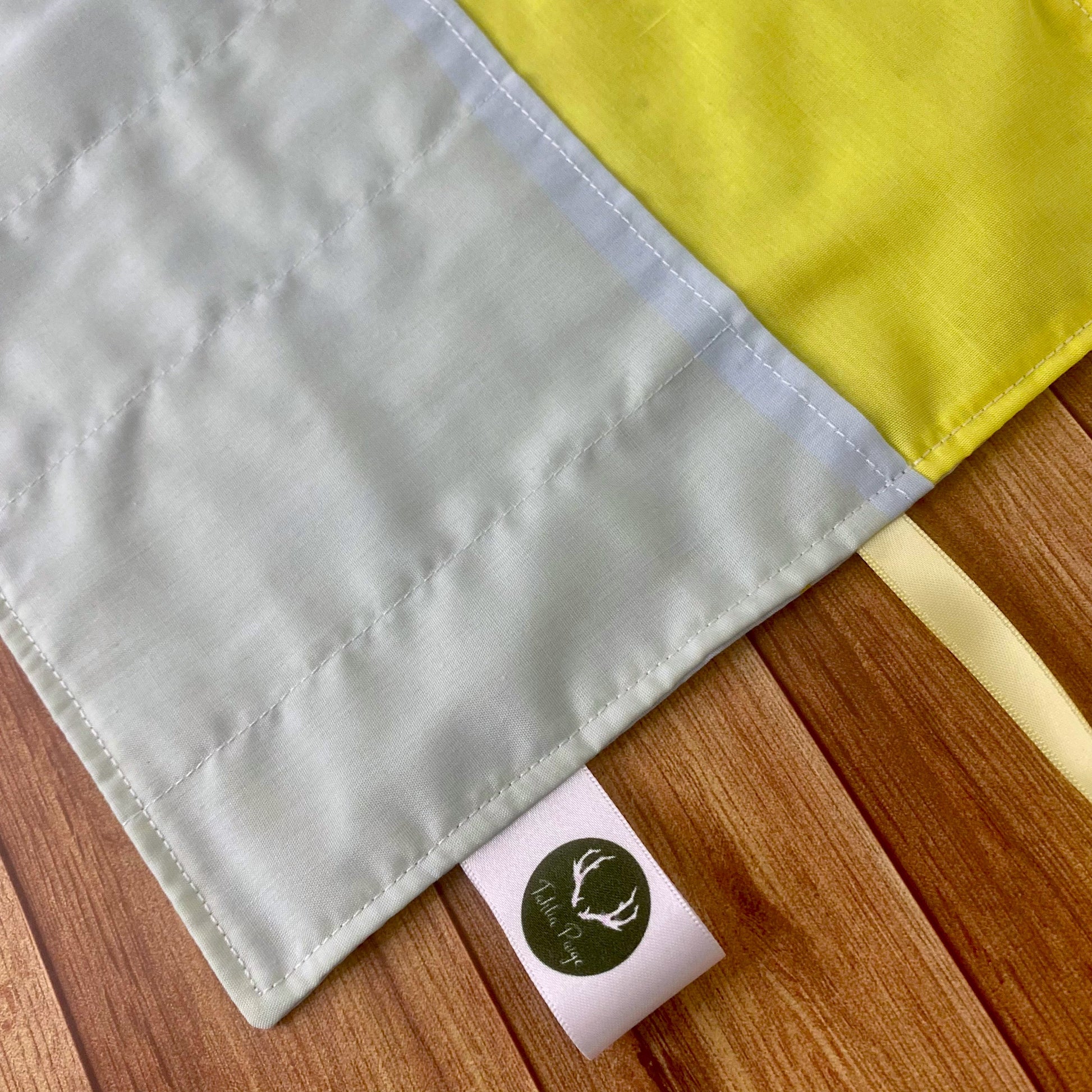 Closeup of inside of brushwrap showing yellow and blue lining, a practical gift for an artist