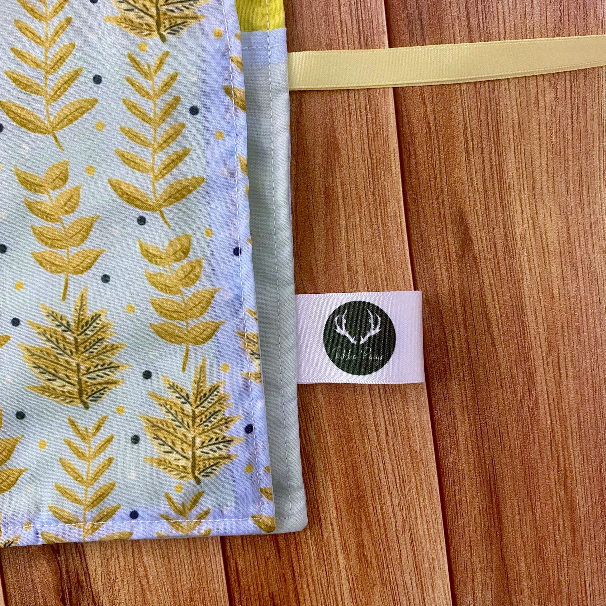 Closeup of corner of brushwrap showing the yellow foliage surface pattern design on the front of the wrap, with an easy roll up design