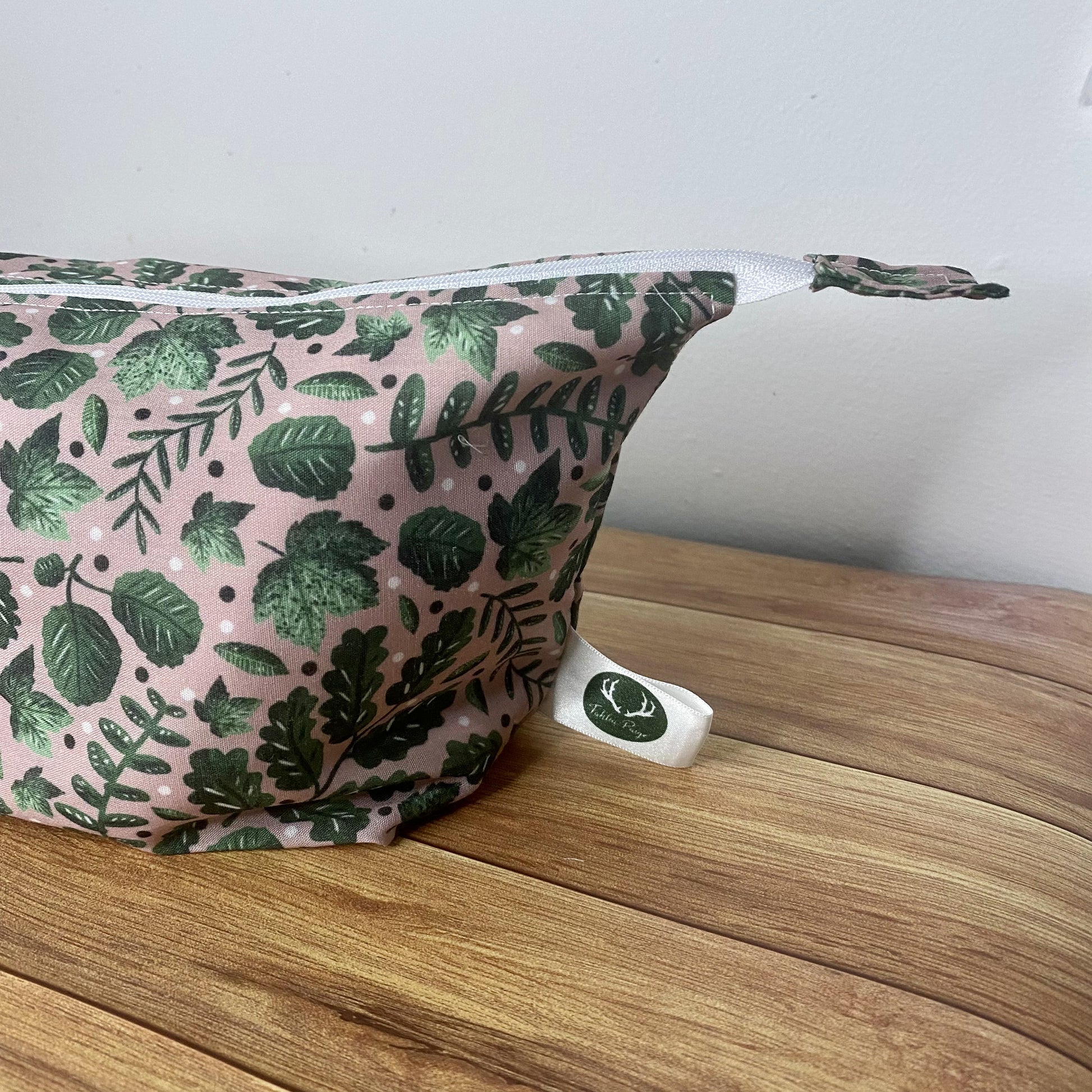green foliage patterned makeup bag side view