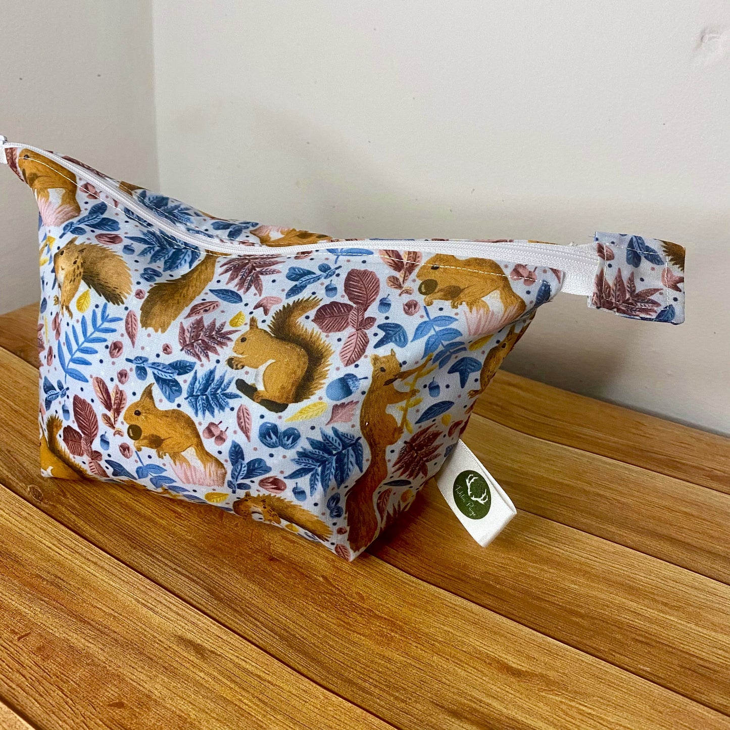 Red squirrel makeup bag stuffed to show the shape and size.