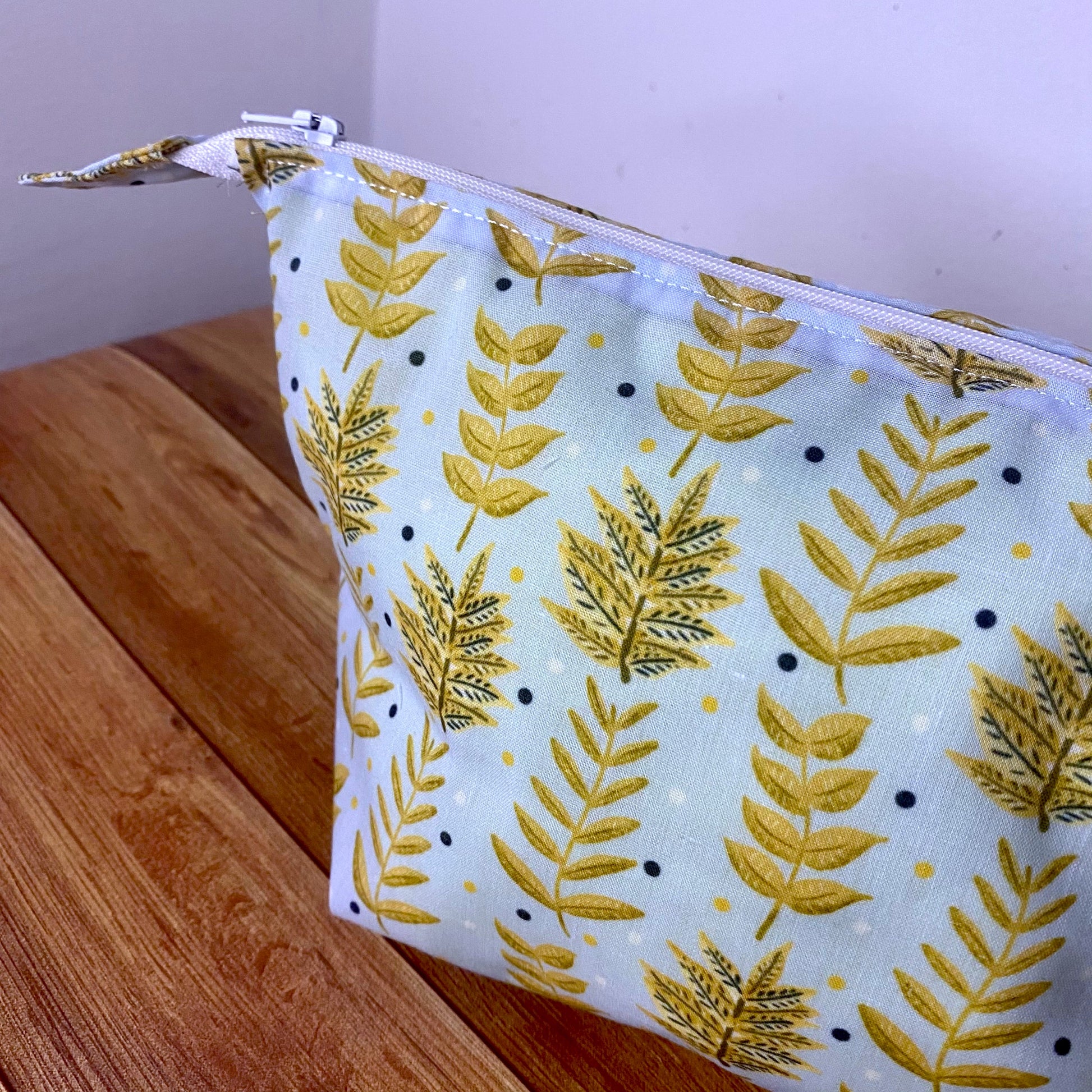 the yellow foliage patterned makeup bag shown stuffed to show the shape.