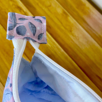 Closeup of open zip showing the blue lining of the makeup bag