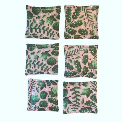 six reusable skincare pads on white background
