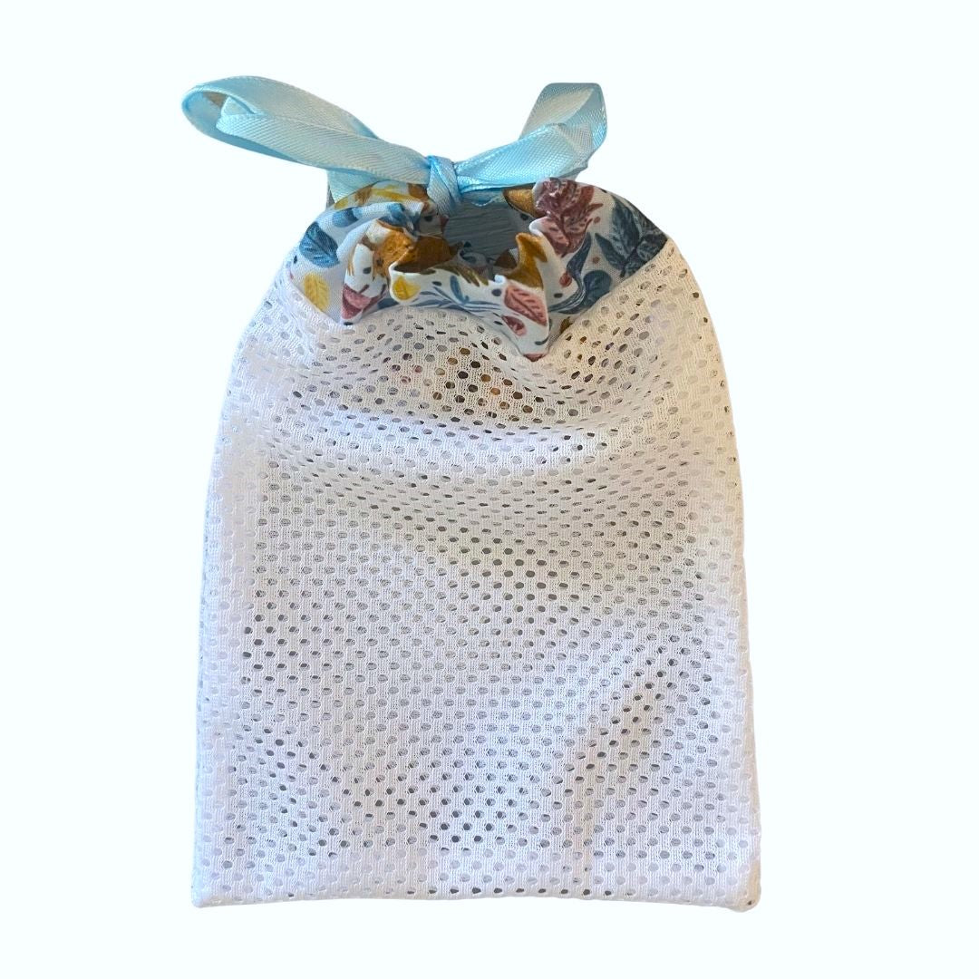 red squirrel patterned washbag with a blue ribbon tying it, on a white background
