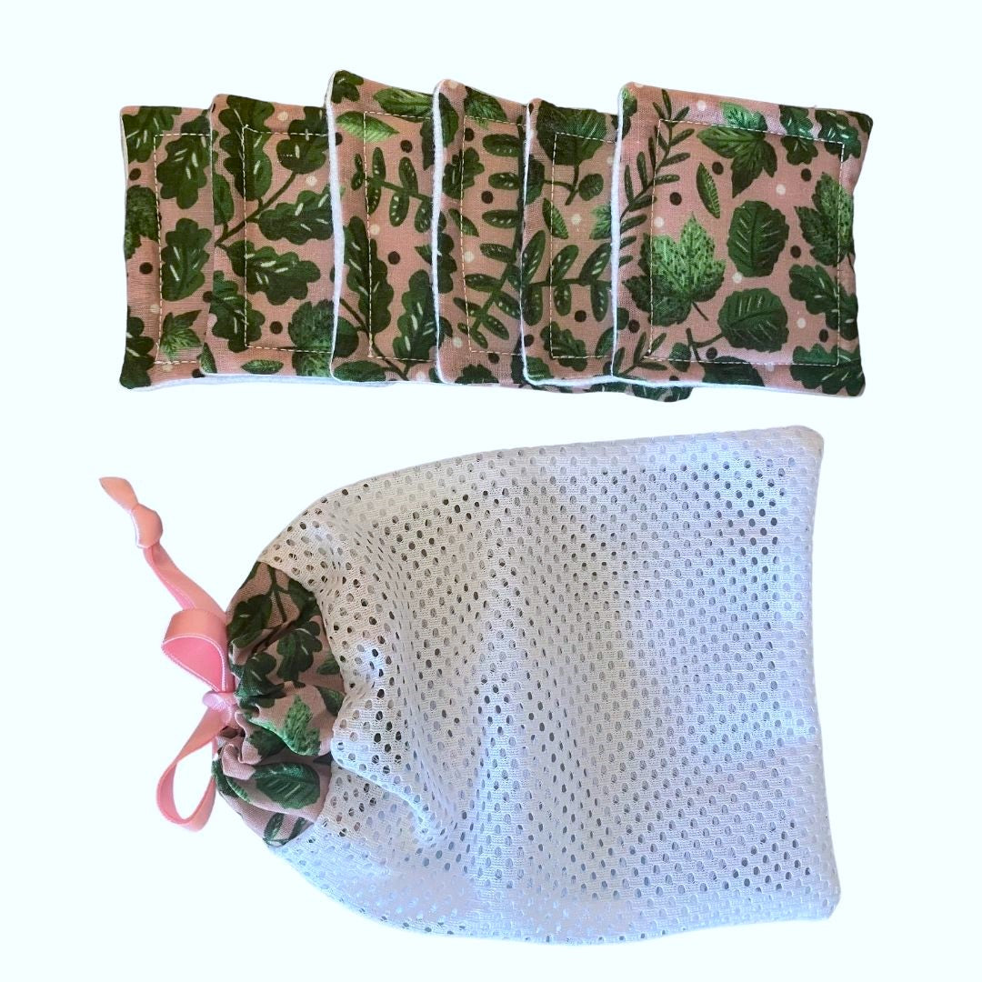 six reusable skincare pads and a matching washbag with the green foliage pattern design on it, on a white background
