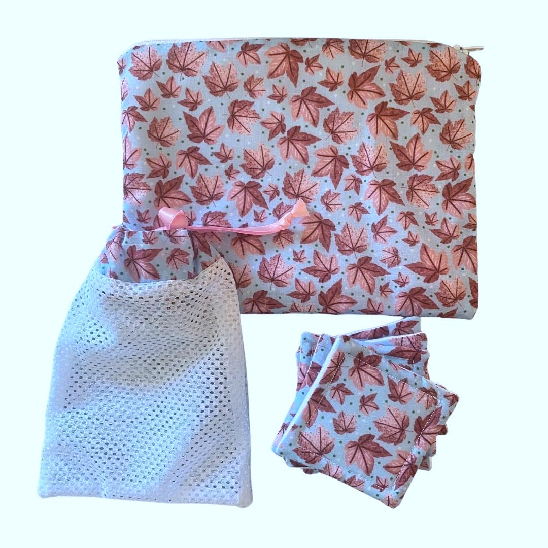 pink leafy patterned pouch, reusable skincare pads and washbag on white background