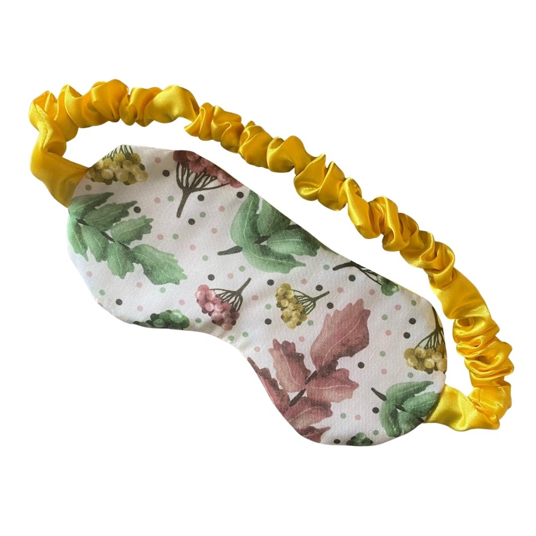 pretty foliage patterned sleepmask with yellow scrunched satin strap on white background