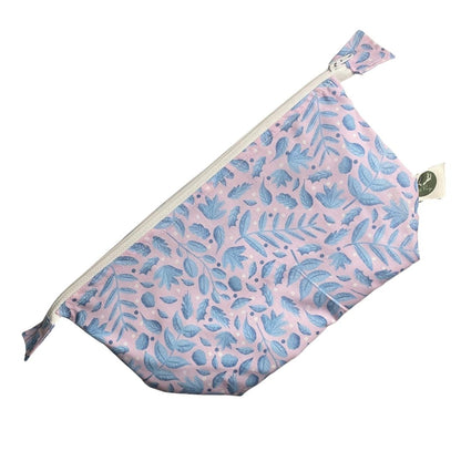 blue and pink foliage pattern on makeup bag with white background behind it