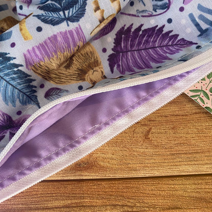 use as a makeup bag for handbag, our hare fabric is shown up close here on the hare storage pouch with a lilac lining inside.