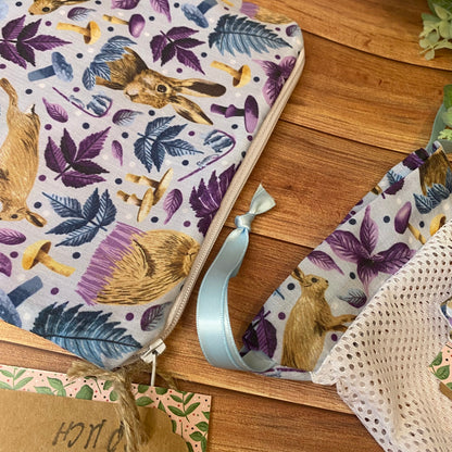 hare patterned pouch and washbag on a wooden surface