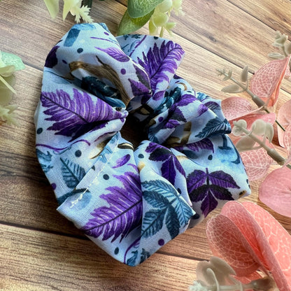 Closeup of the hare patterned scrunchie on a wooden background