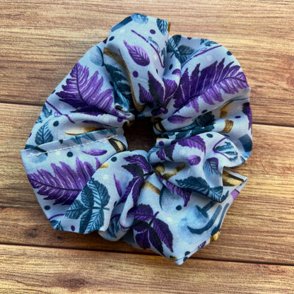 Closeup of hare patterned scrunchie on wooden backdrop