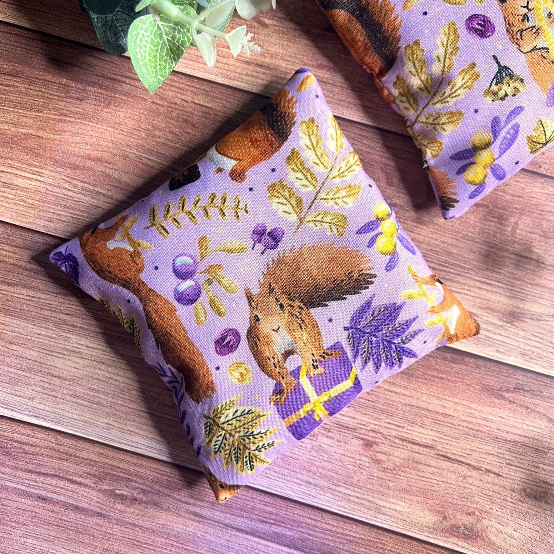 Enjoy nature lover gift ideas here with our best hand warmers. These are purple with a red squirrel pattern, and can make an ideal gift for nan.