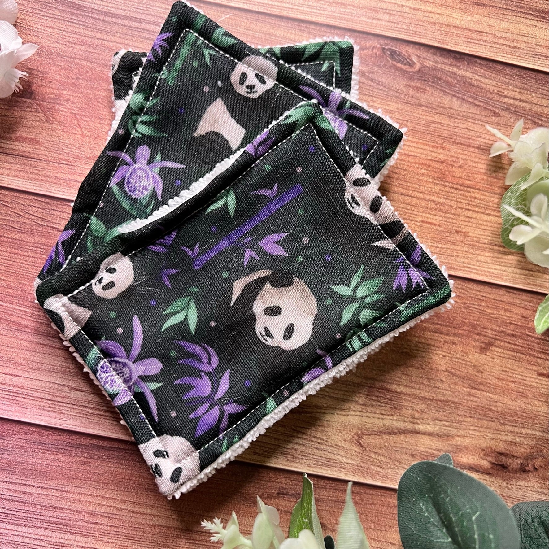 shop panda gift ideas for our panda exfoliating face pads here with a purple background and towelling on the back for skincare.