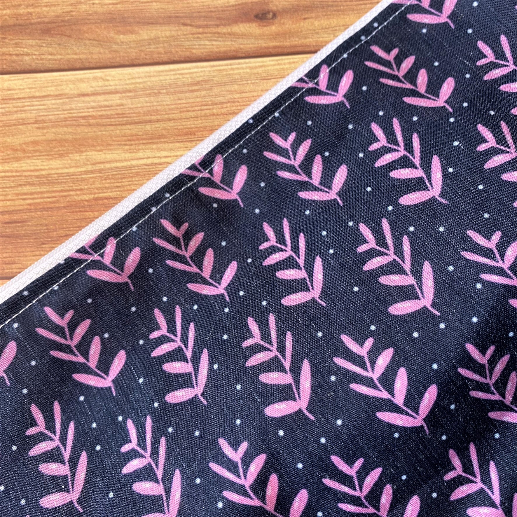 close up of the dark foliage pattern with pink leaves.