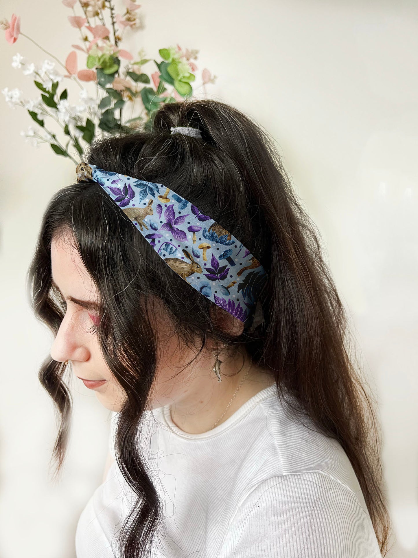 dark haired girl wears hare pattern headband