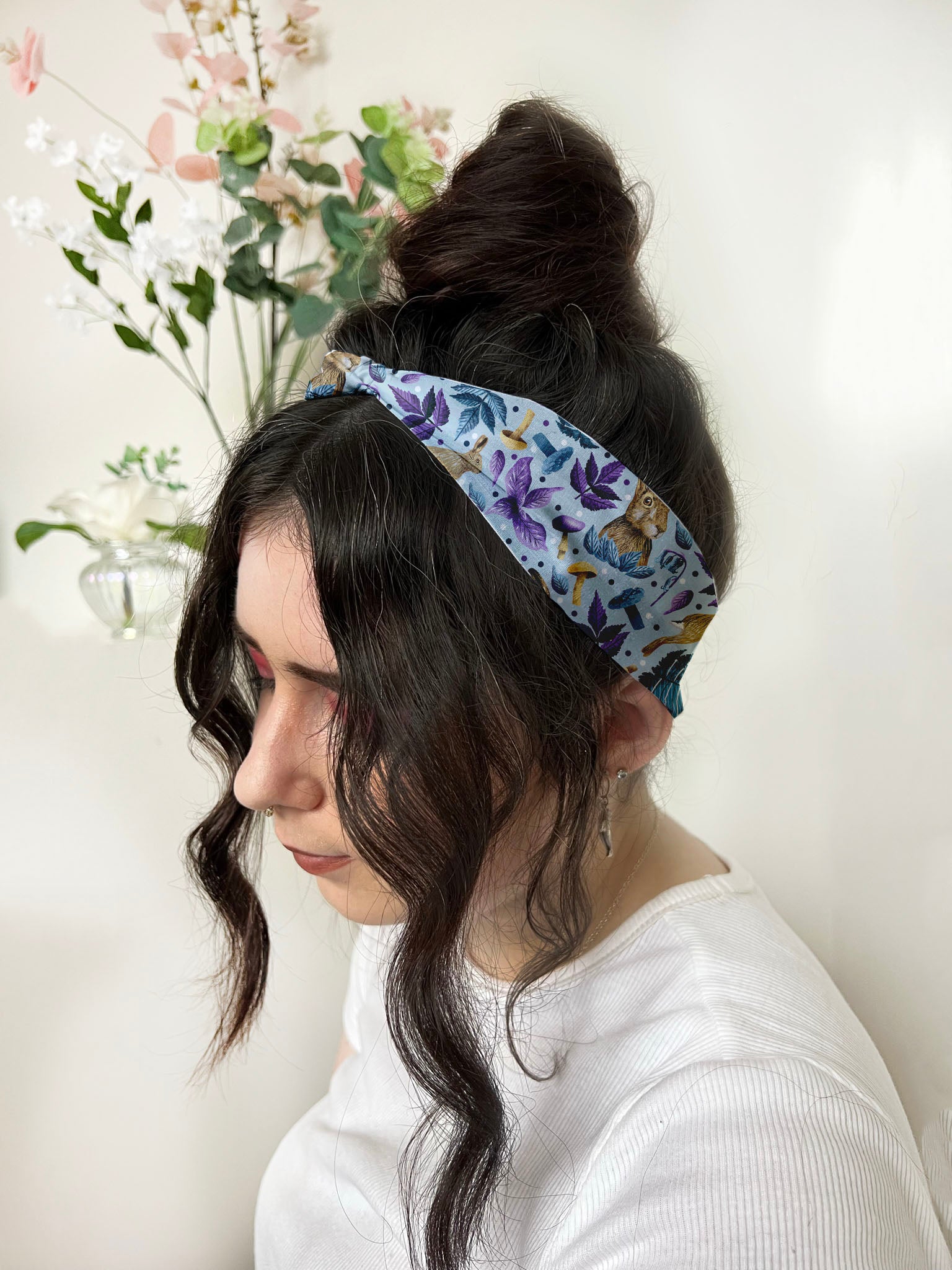 dark haired girl wears a hare patterned headband 