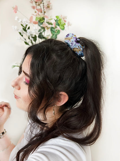 dark haired girl with blue hare patterned scrunchie around a ponytail