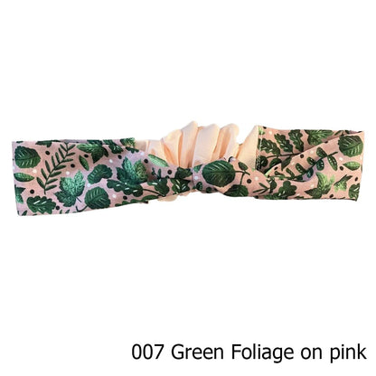 green foliage patterned headband on white background