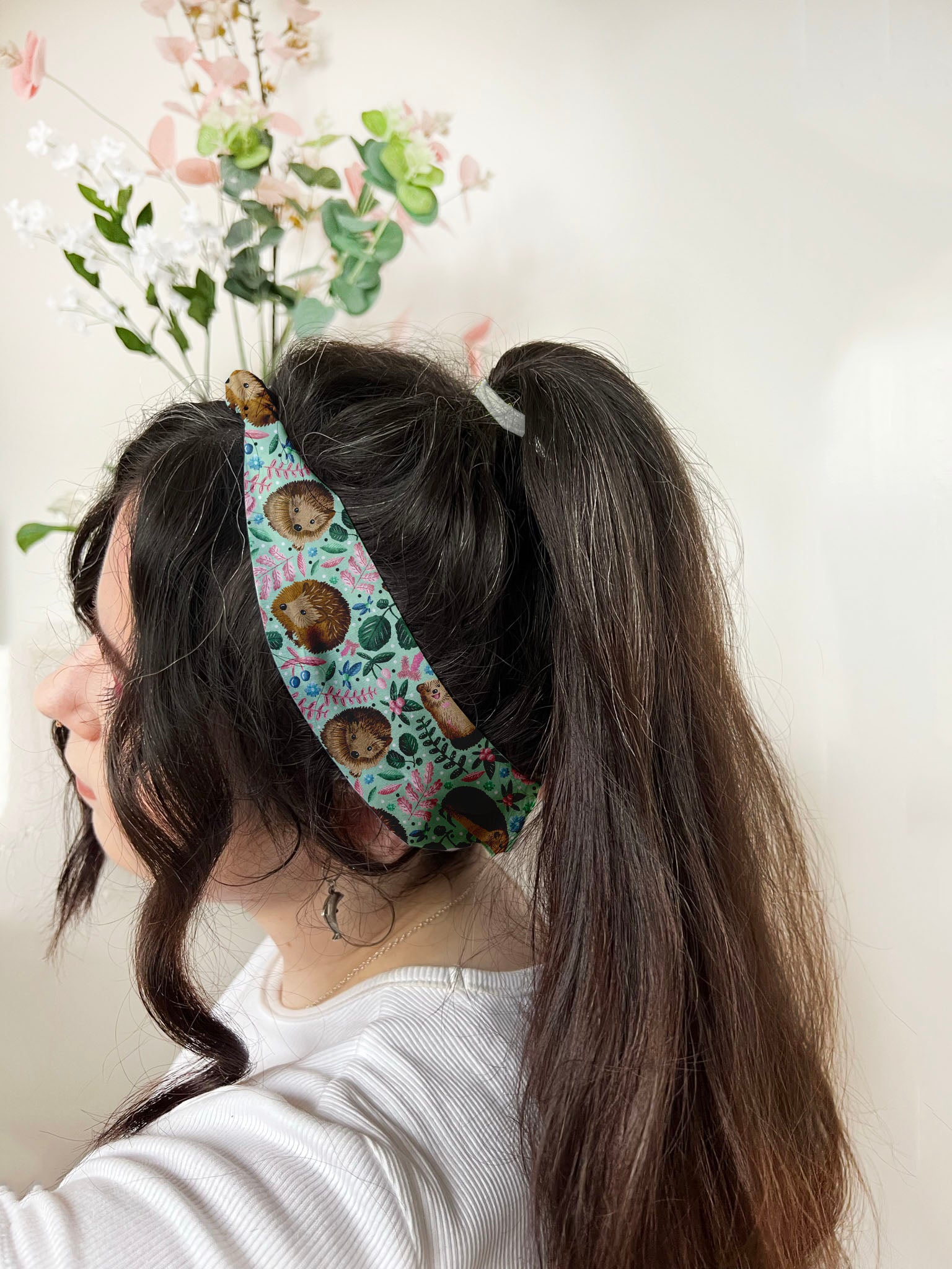 dark haired girl with hedgehog patterned headband, an ideal hedgehog hair accessory for the lover of hedgehogs.