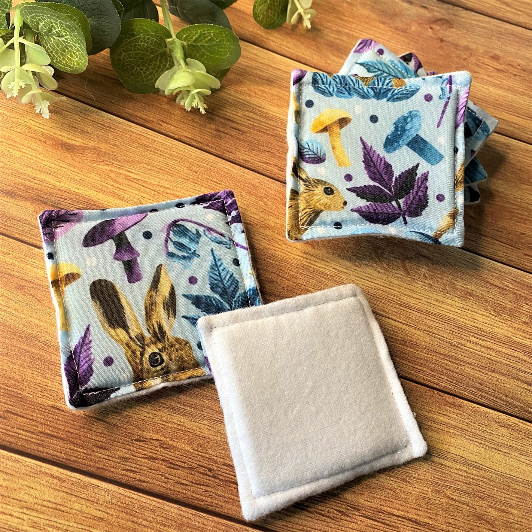 Hare patterned skincare pads on a wooden background