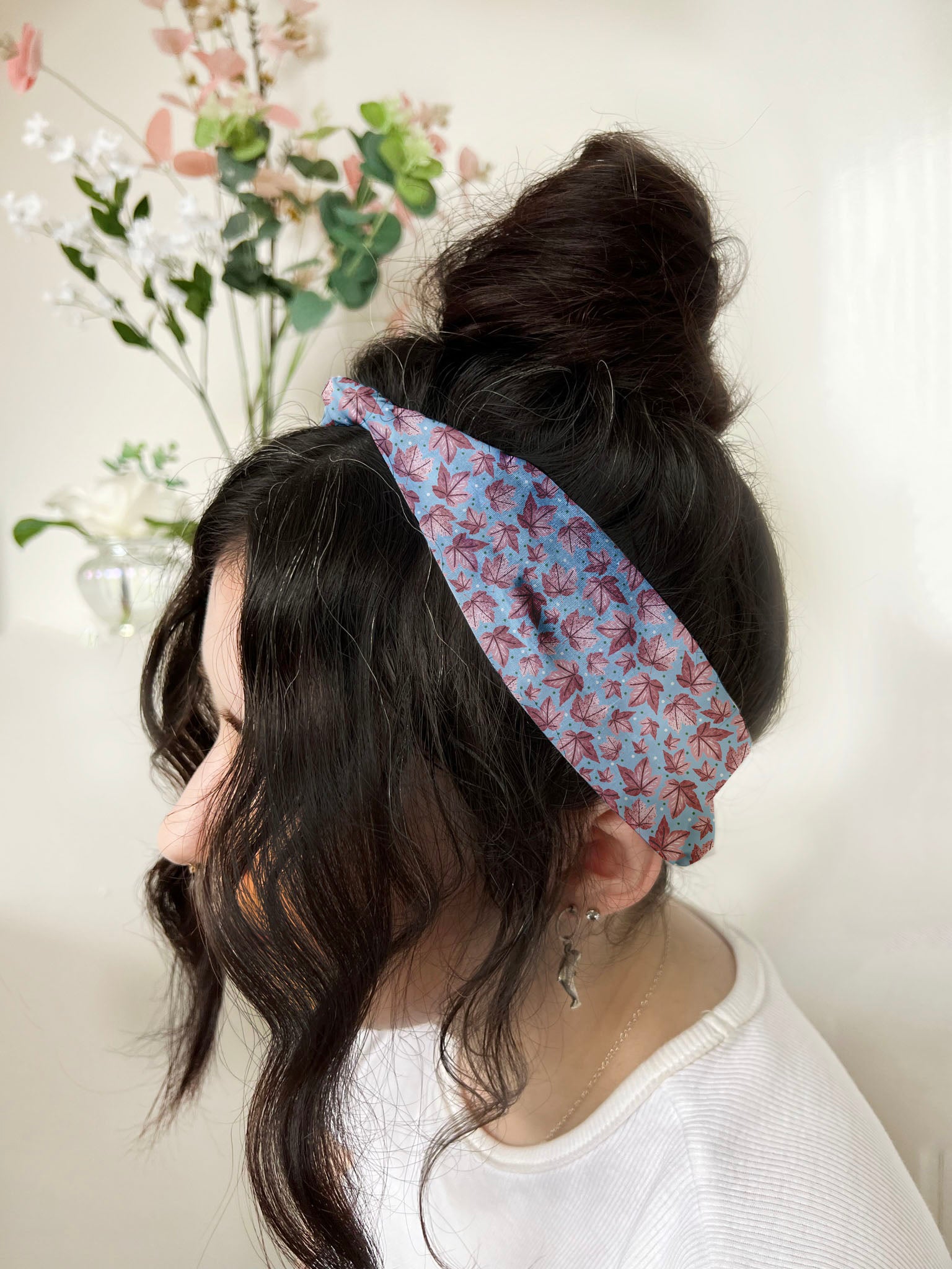 dark haired girl wears pink leafy headband, ideal as a hair accessories for long hair.