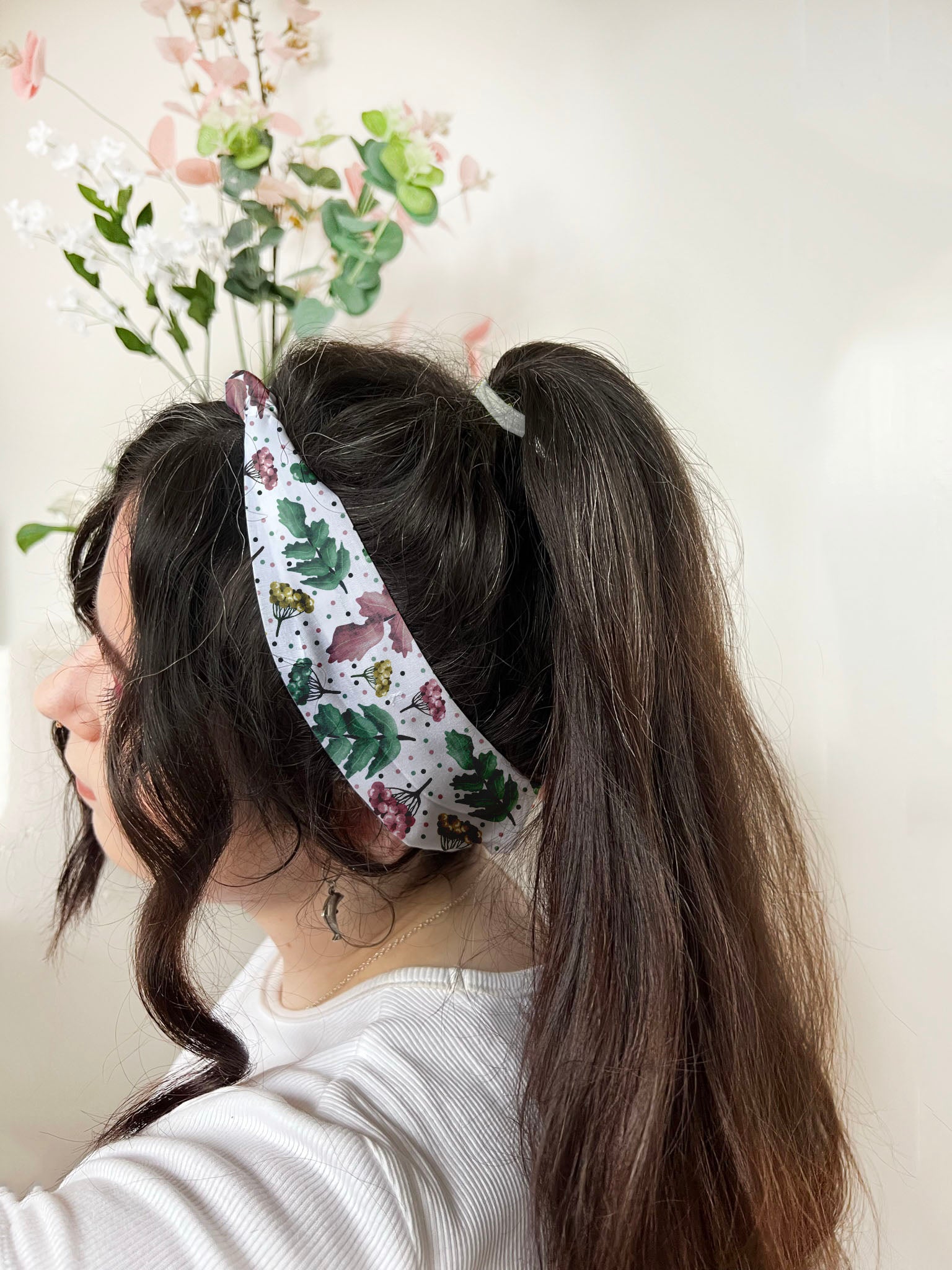 dark haired girl wears pretty foliage headband, ideal as a gift for her for fashion and for skincare use