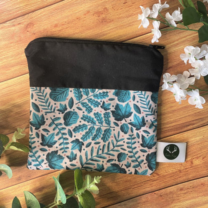 Shop a coin purse pouch as a handmade gift for mom right here in wales. This photos shows the turquiose leaf pattern with a black border.