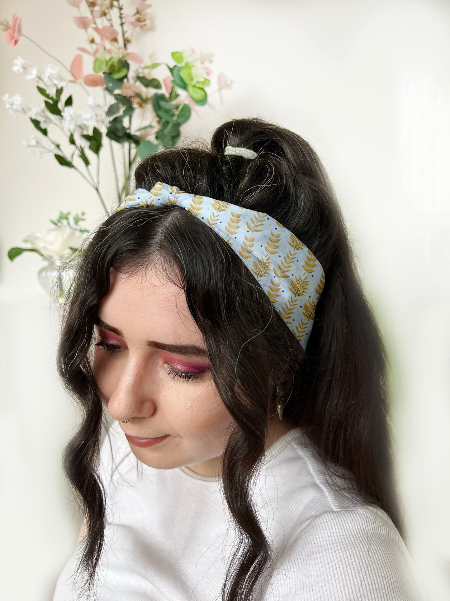 dark haired girl wears yellow foliage patterned headband in hair, an ideal gift for fiance
